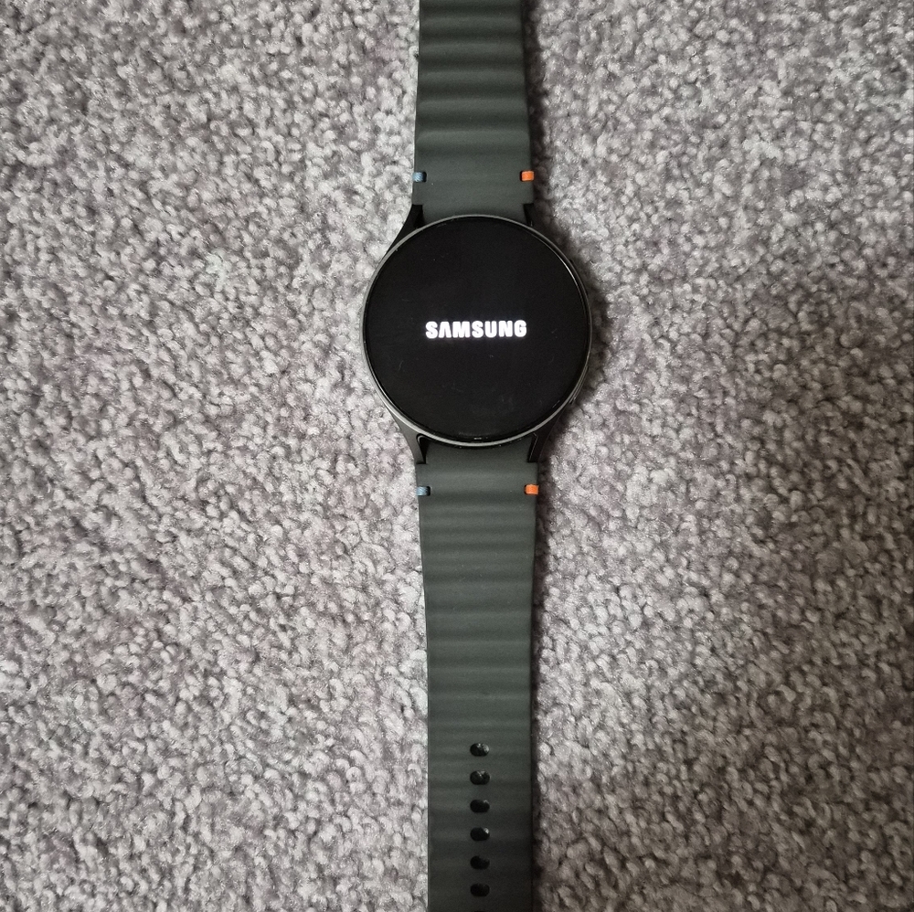 Unlocked Samsung Smartwatch with Black Display and Dark Gray Band.